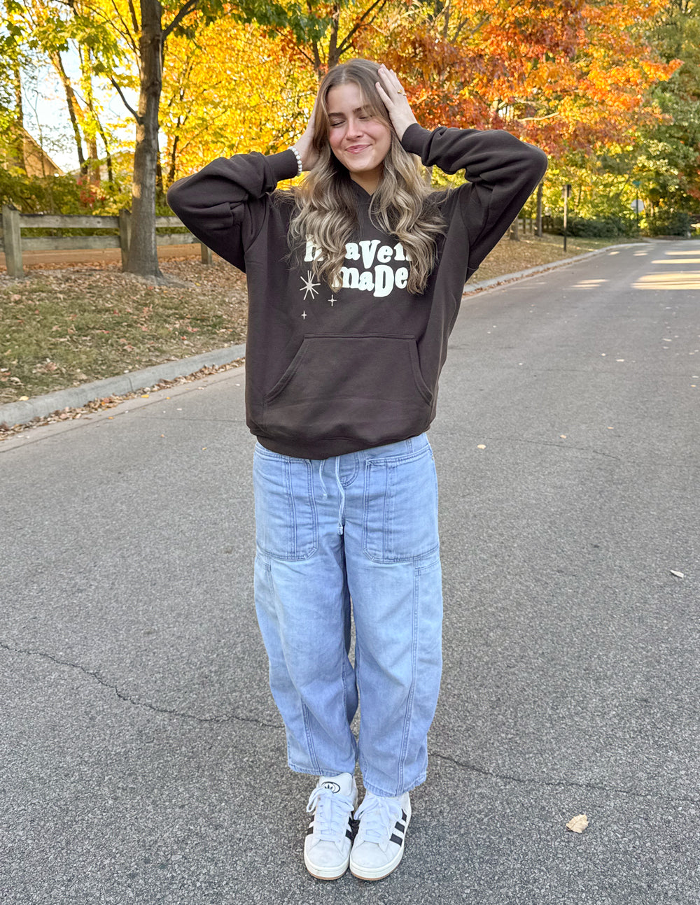 Dark brown unisex hoodie with “Heaven Made” print; long sleeves and front kangaroo pocket.