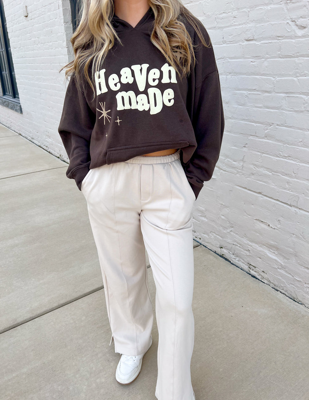 Dark brown unisex hoodie front view with “Heaven Made” print and hooded neckline.