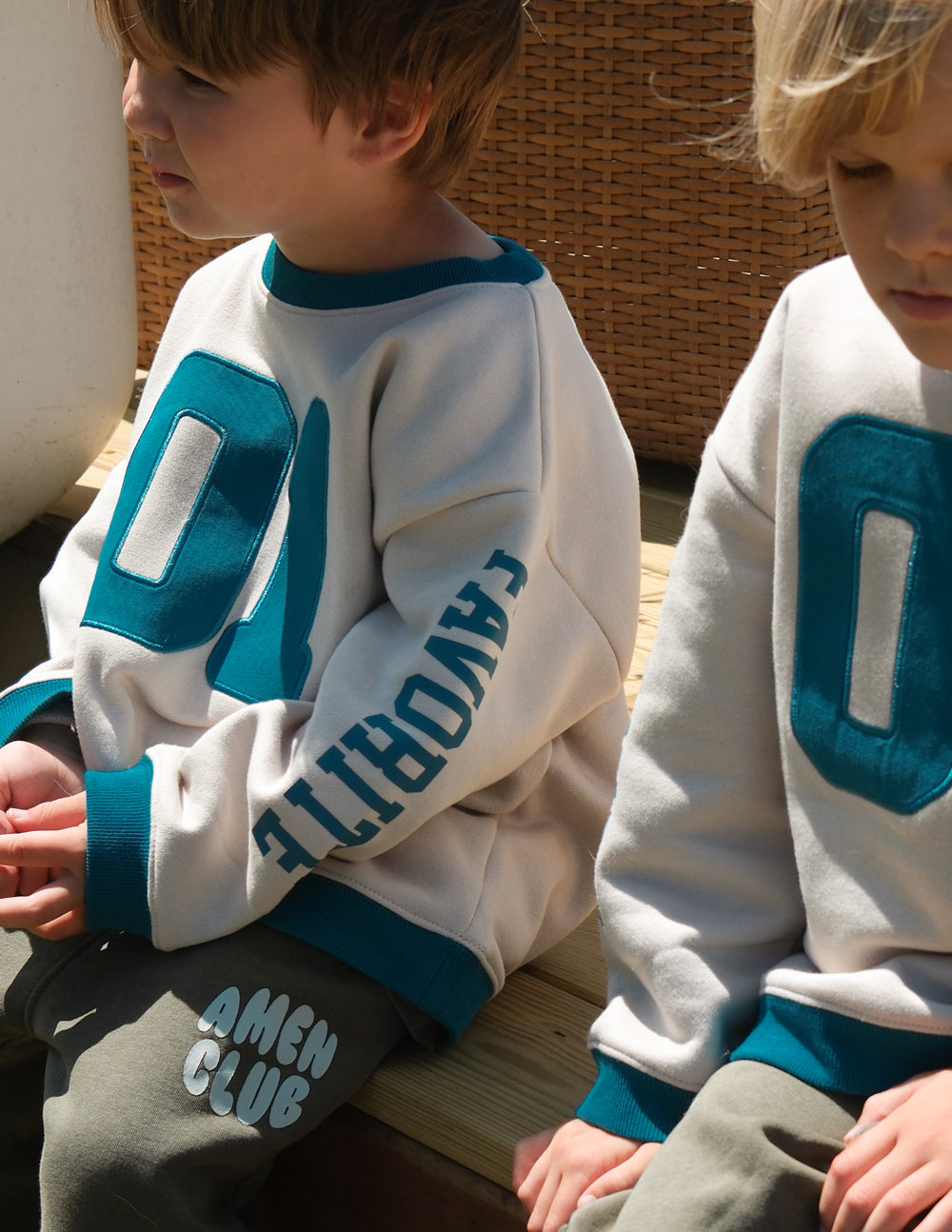 Kids crewneck sweatshirt in cream with teal number 01 and sleeve graphic