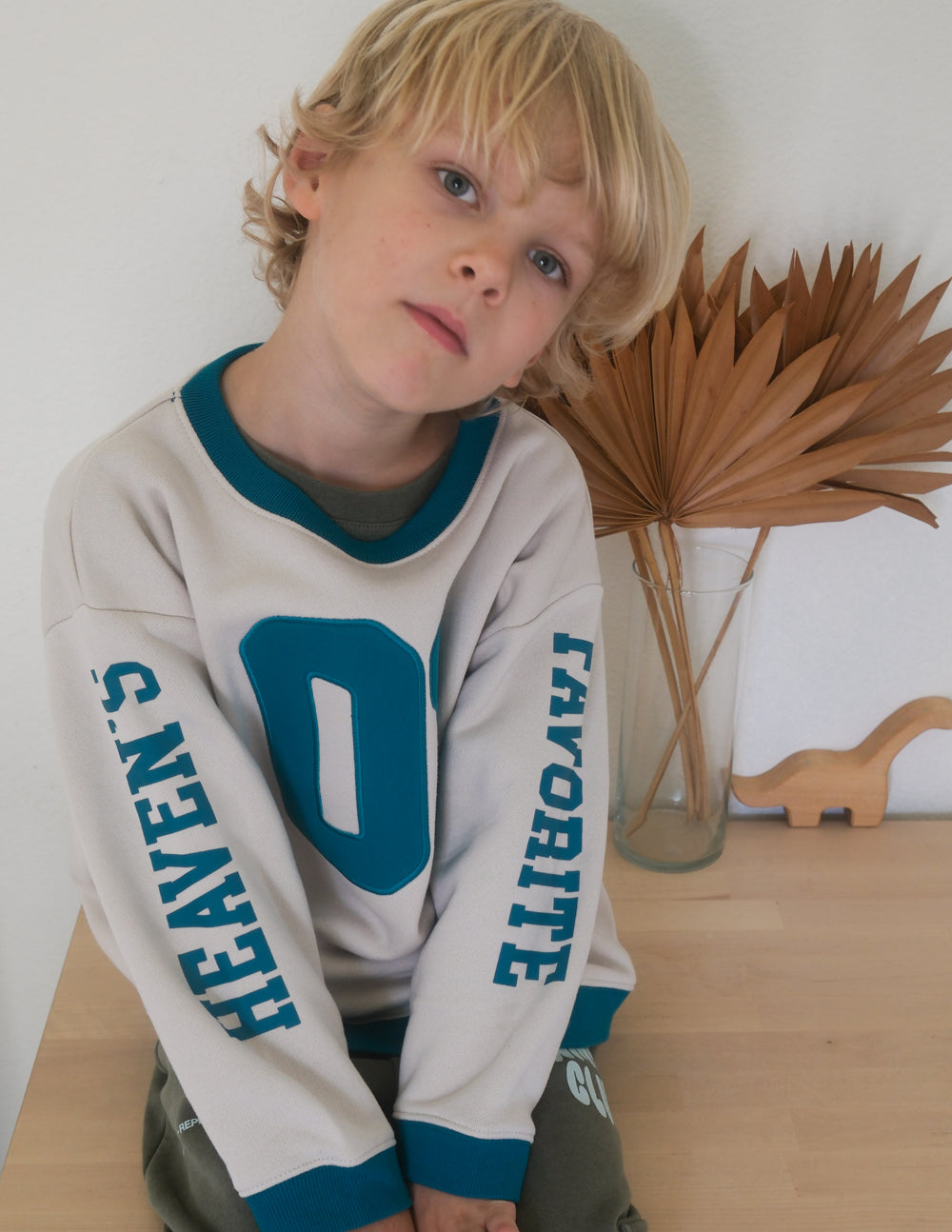 Kids crewneck sweatshirt in cream with teal number 01 and teal sleeve text