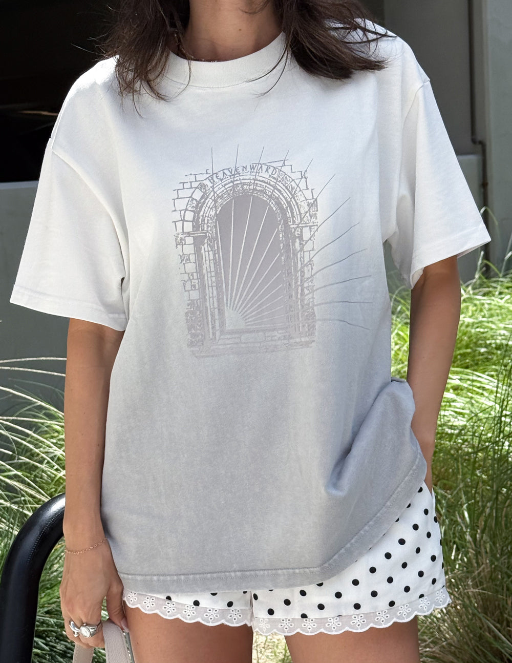 White heavyweight tee with arched graphic print on the chest, short sleeves.