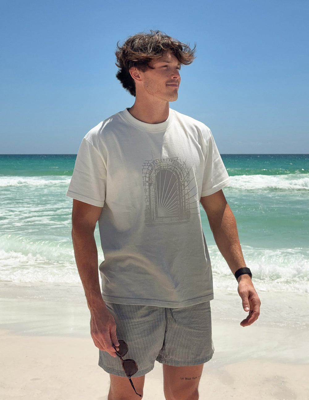 White heavyweight tee with arched graphic print on the chest, short sleeves.
