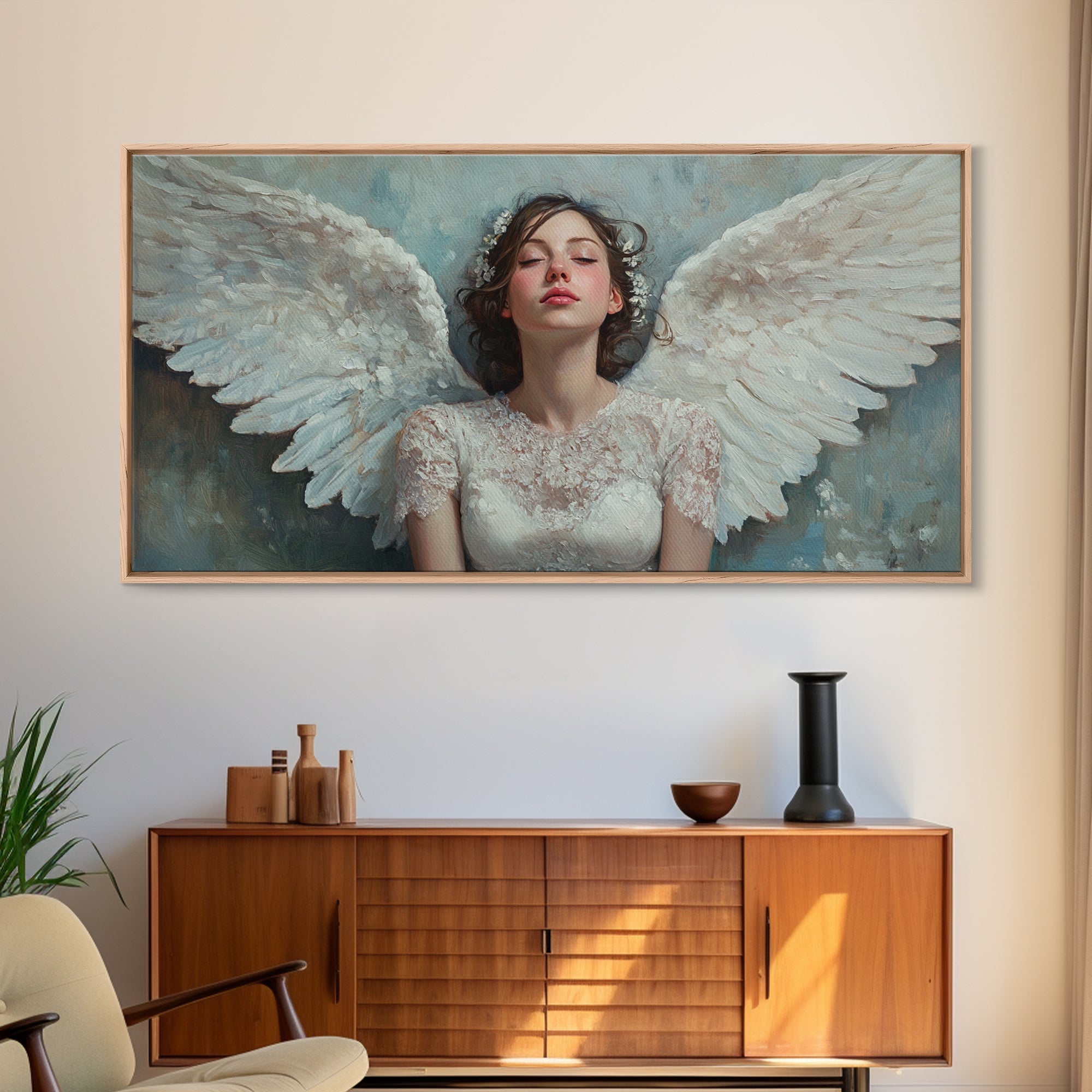 Framed angel canvas print with pastel blue sky and white wings, light wood frame