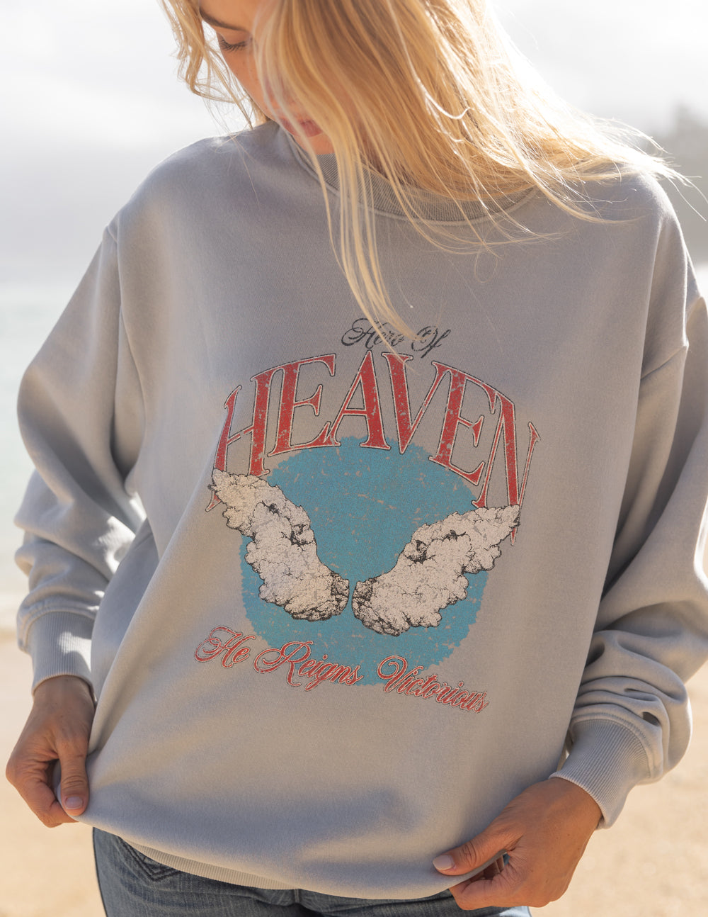 Unisex crewneck sweatshirt, light gray, back view with red Heaven logo and blue map graphic