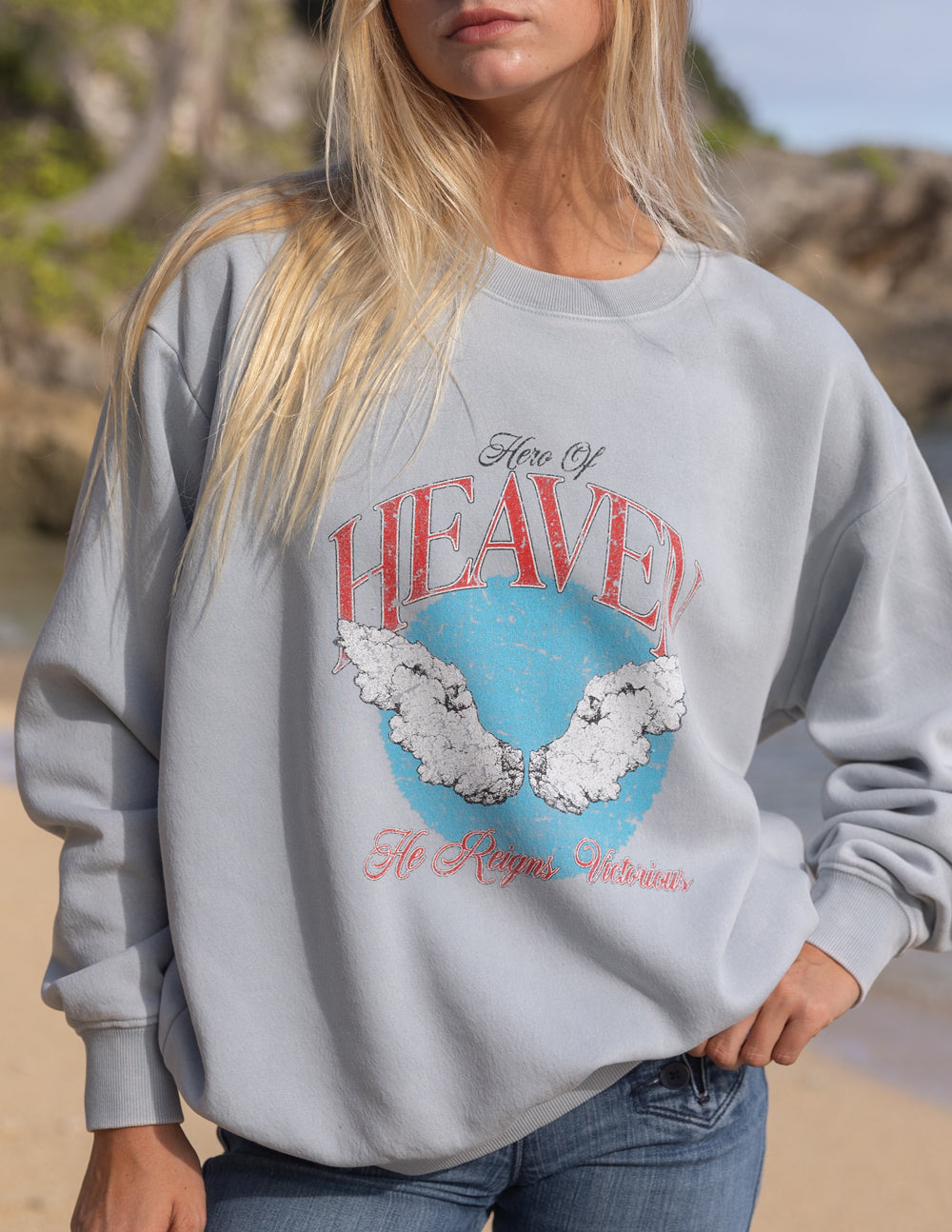 Unisex crewneck sweatshirt, light gray, close front view of red and blue Heaven graphic