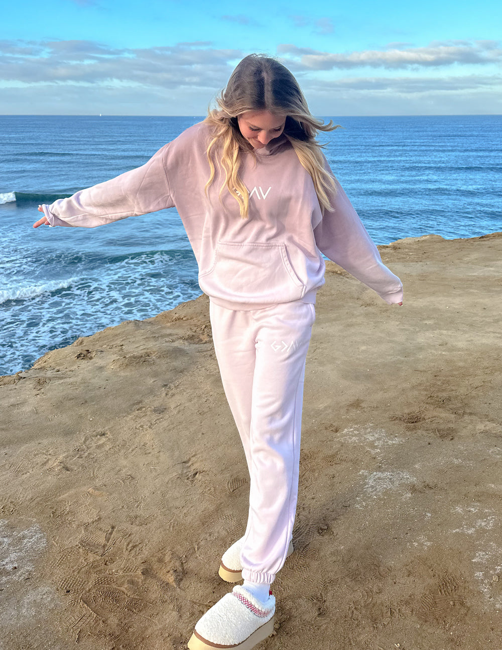 Light purple unisex sweatpants with ankle cuffs and thigh logo