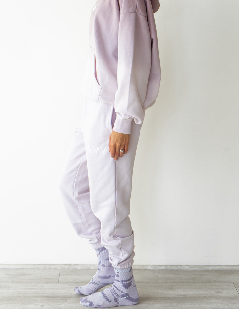 Light purple unisex sweatpants with tapered cuffs and embroidered leg logo