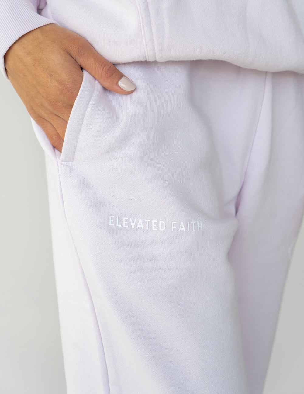 Light purple unisex sweatpants with back text logo and relaxed waistband