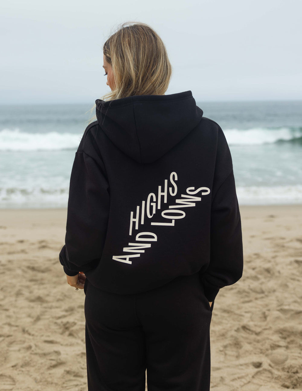Black unisex pullover hoodie with large back logo graphic and hood