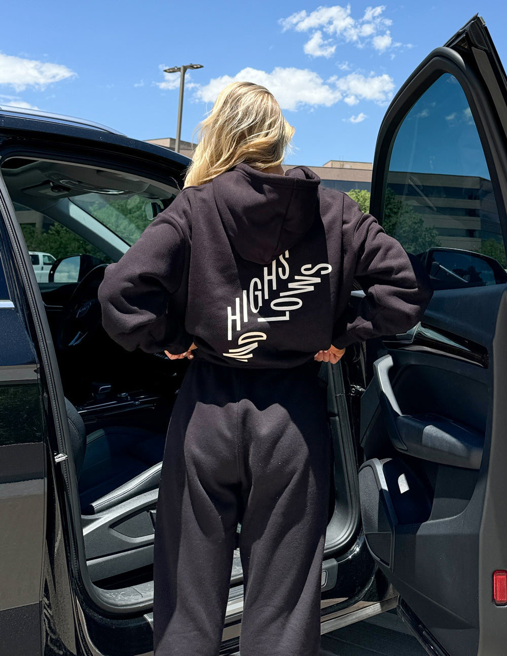 Dark unisex pullover hoodie with large back logo graphic and hood