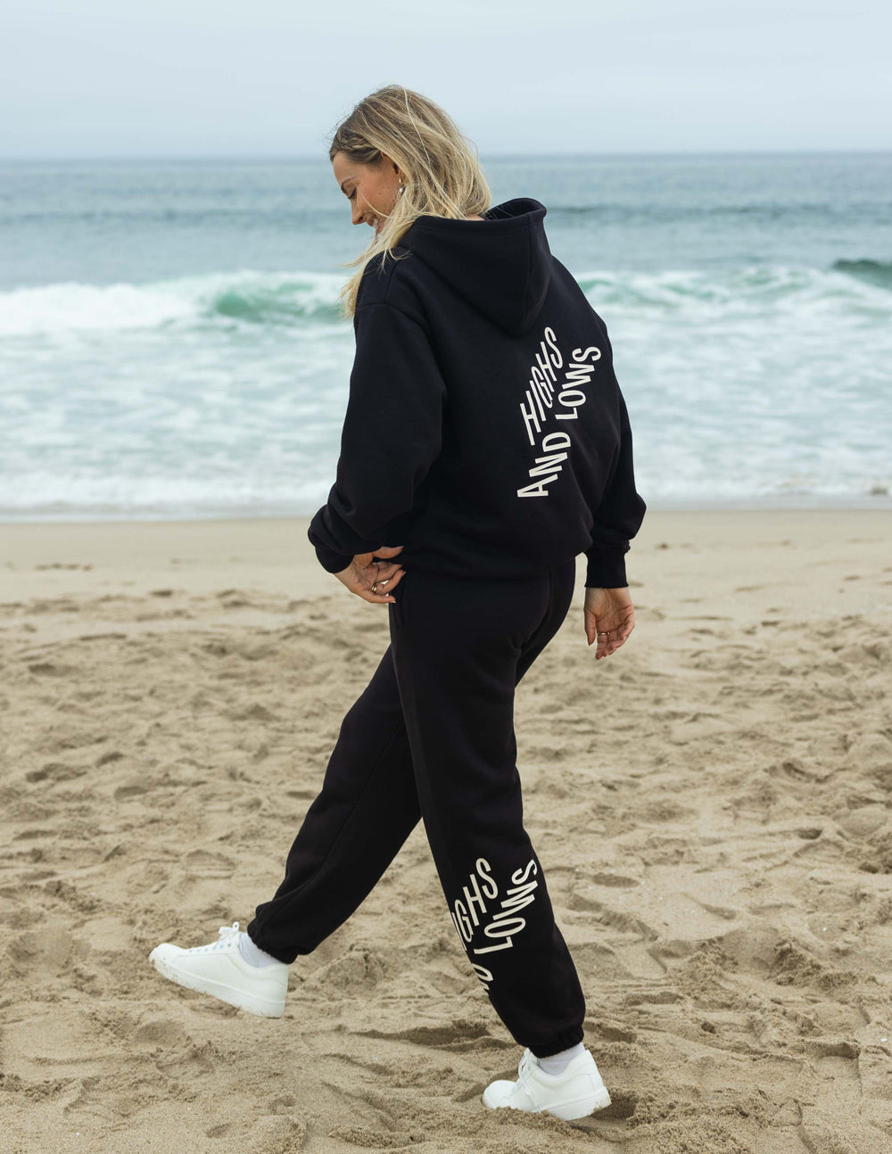 Unisex black sweatpants with white logo print on calf and ribbed ankle cuffs