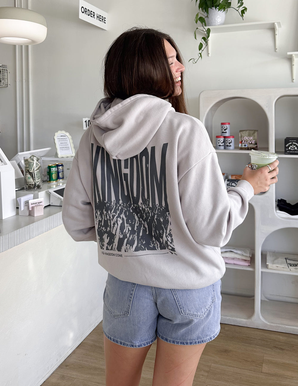 Light gray unisex hoodie, back view with KINGDOM graphic; hood and kangaroo pocket