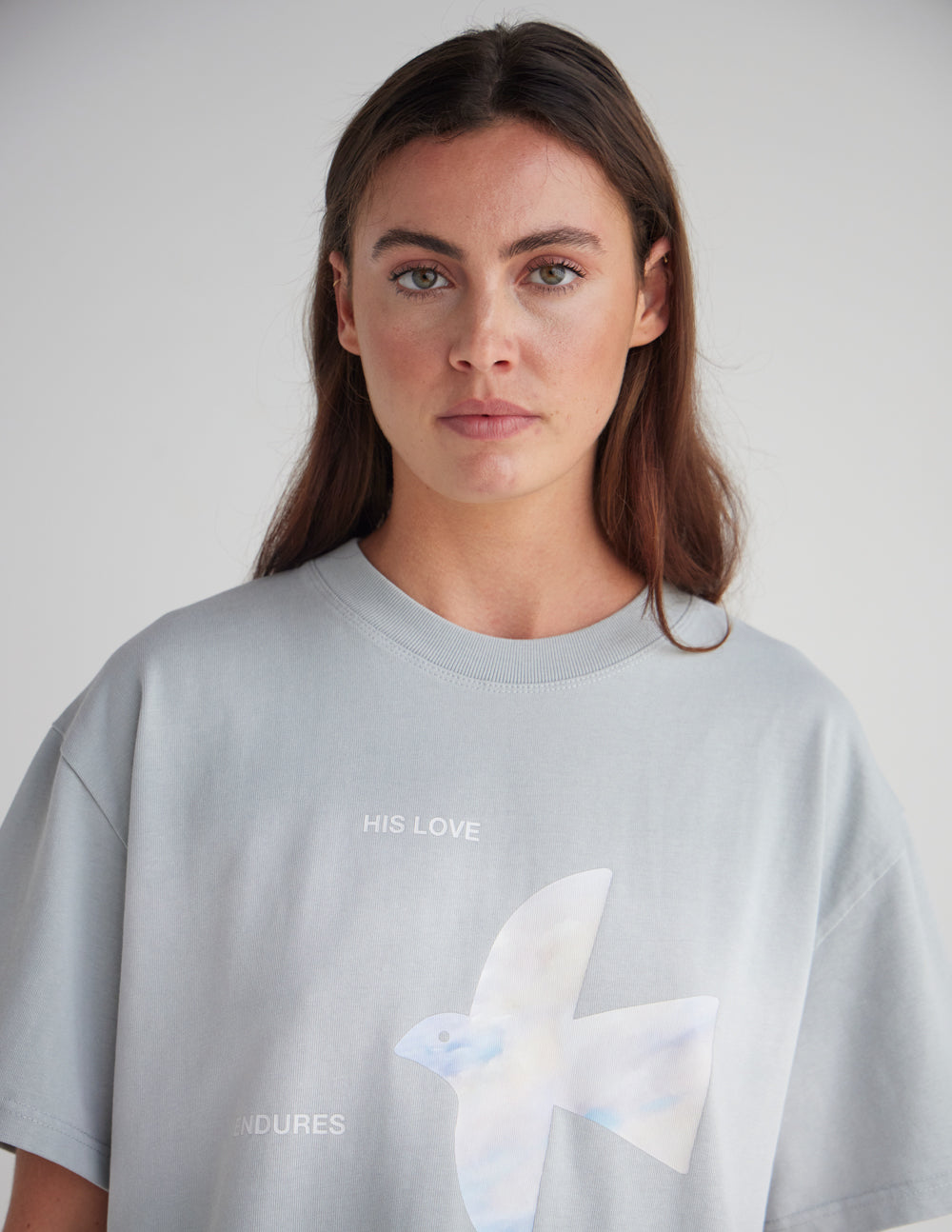 Light blue heavyweight T-shirt with white dove graphic and centered text