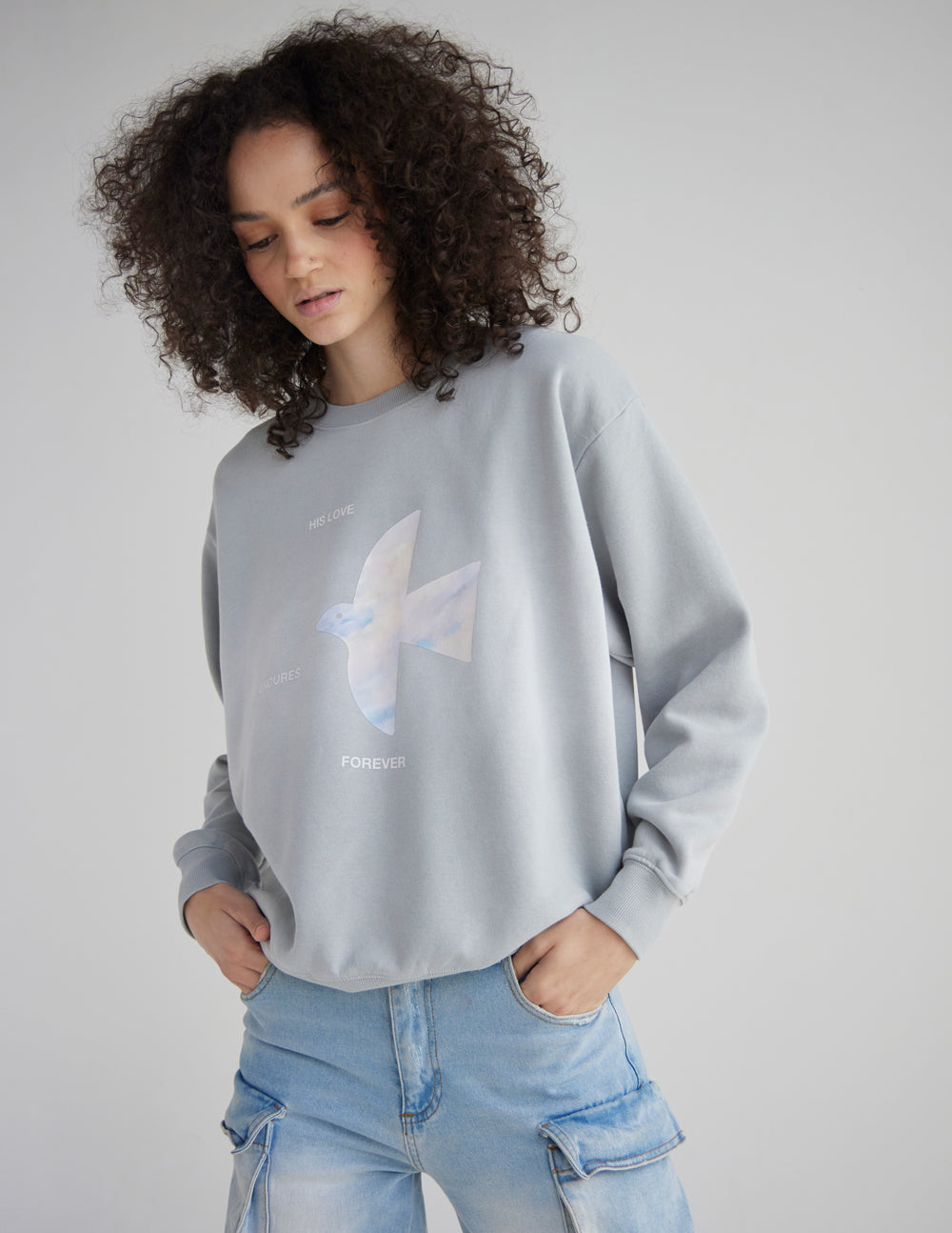 Light gray unisex crewneck sweatshirt with front angel graphic, relaxed fit