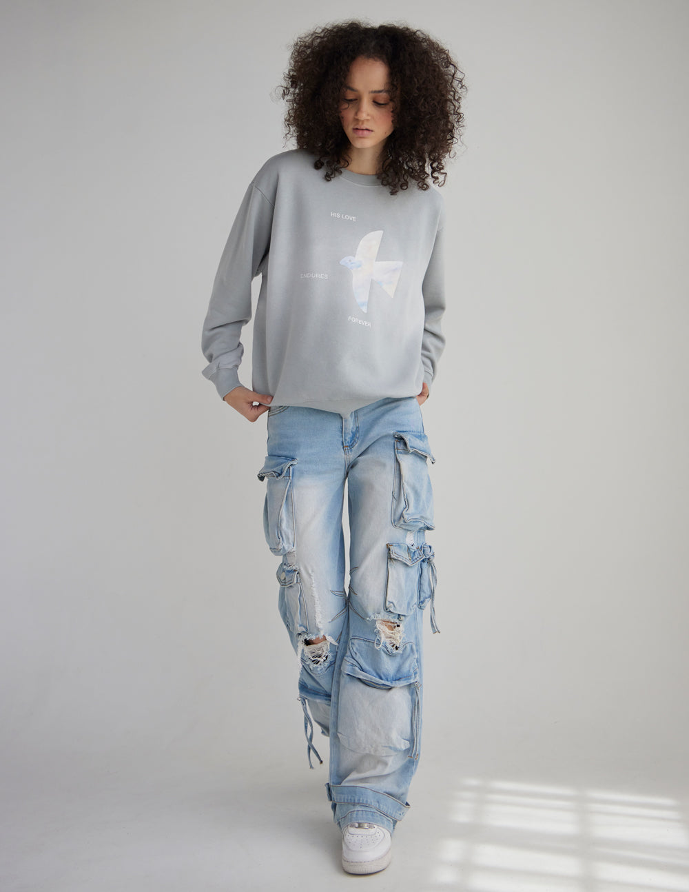 Light gray unisex crewneck sweatshirt with long sleeves and front angel graphic