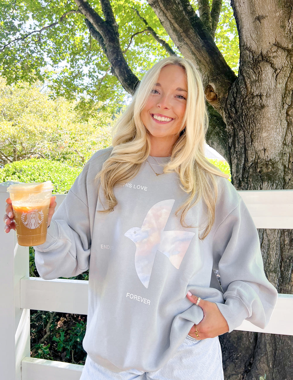 Light gray unisex crewneck sweatshirt with large front angel graphic and text