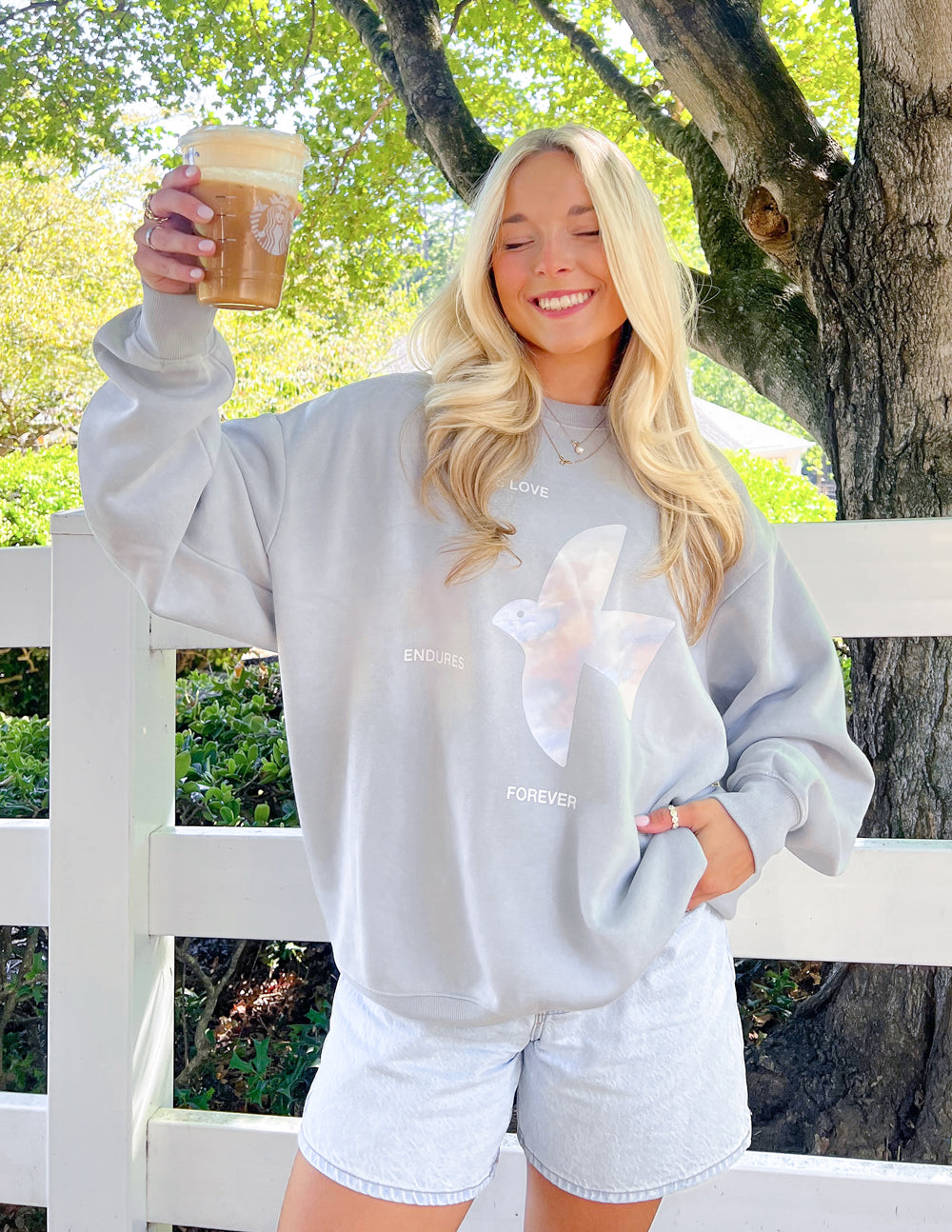 Light gray unisex crewneck sweatshirt, loose fit, angel graphic on front