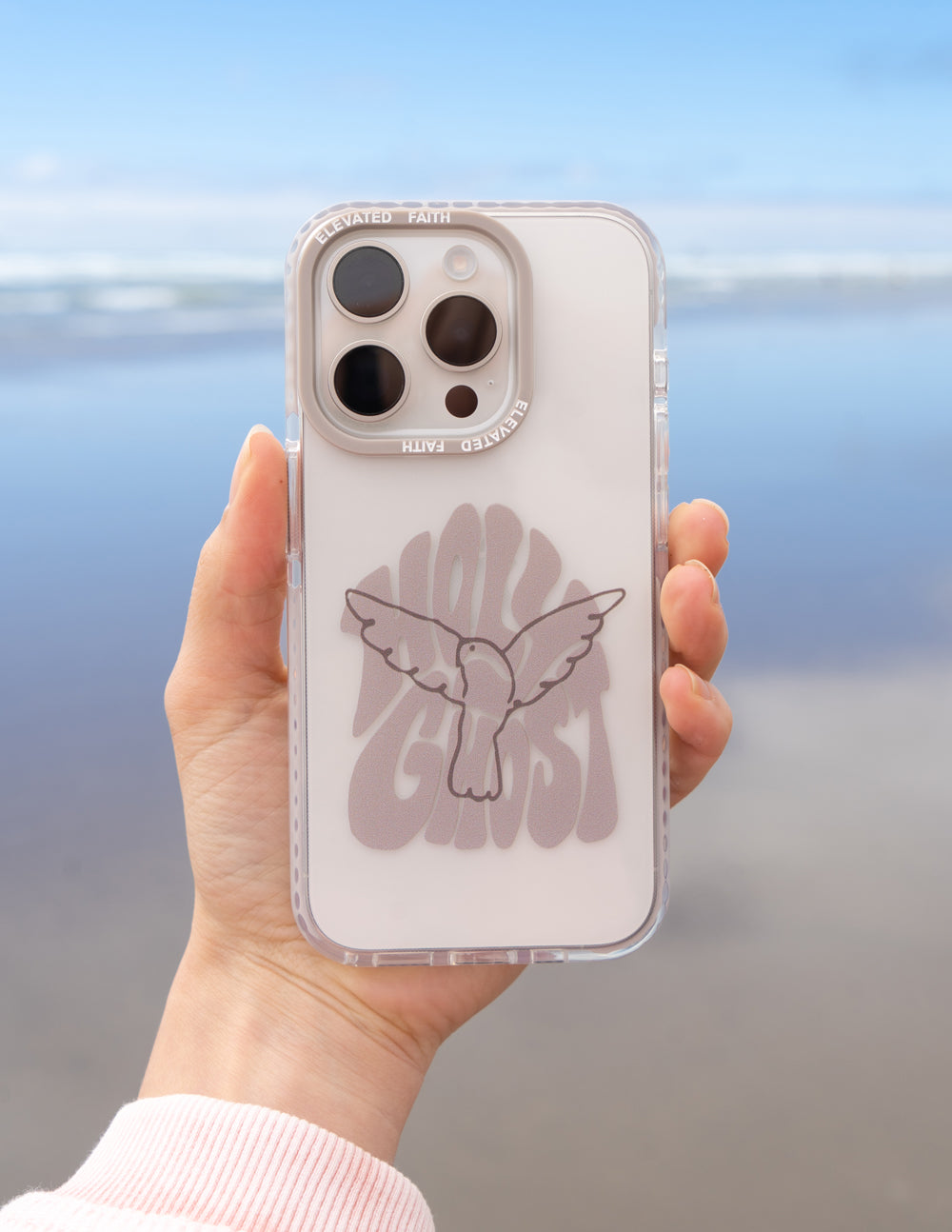 Holy Ghost phone case, transparent design with dove artwork, shown in hand