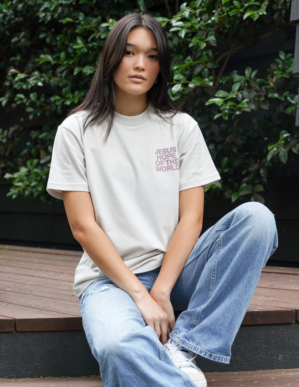 Unisex graphic tee, white, with small front logo text "JESUS HOPE OF THE WORLD"