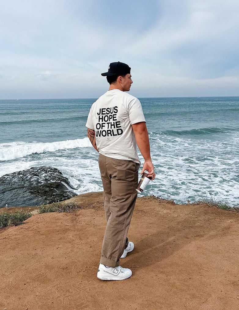 Unisex graphic tee, white, with back text "JESUS HOPE OF THE WORLD"