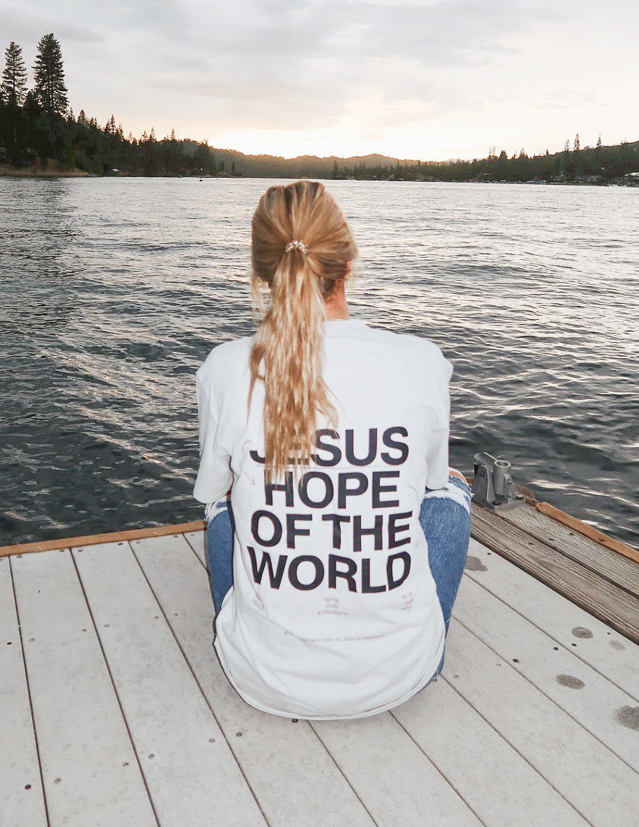 Unisex graphic tee, white, large back text "JESUS HOPE OF THE WORLD"