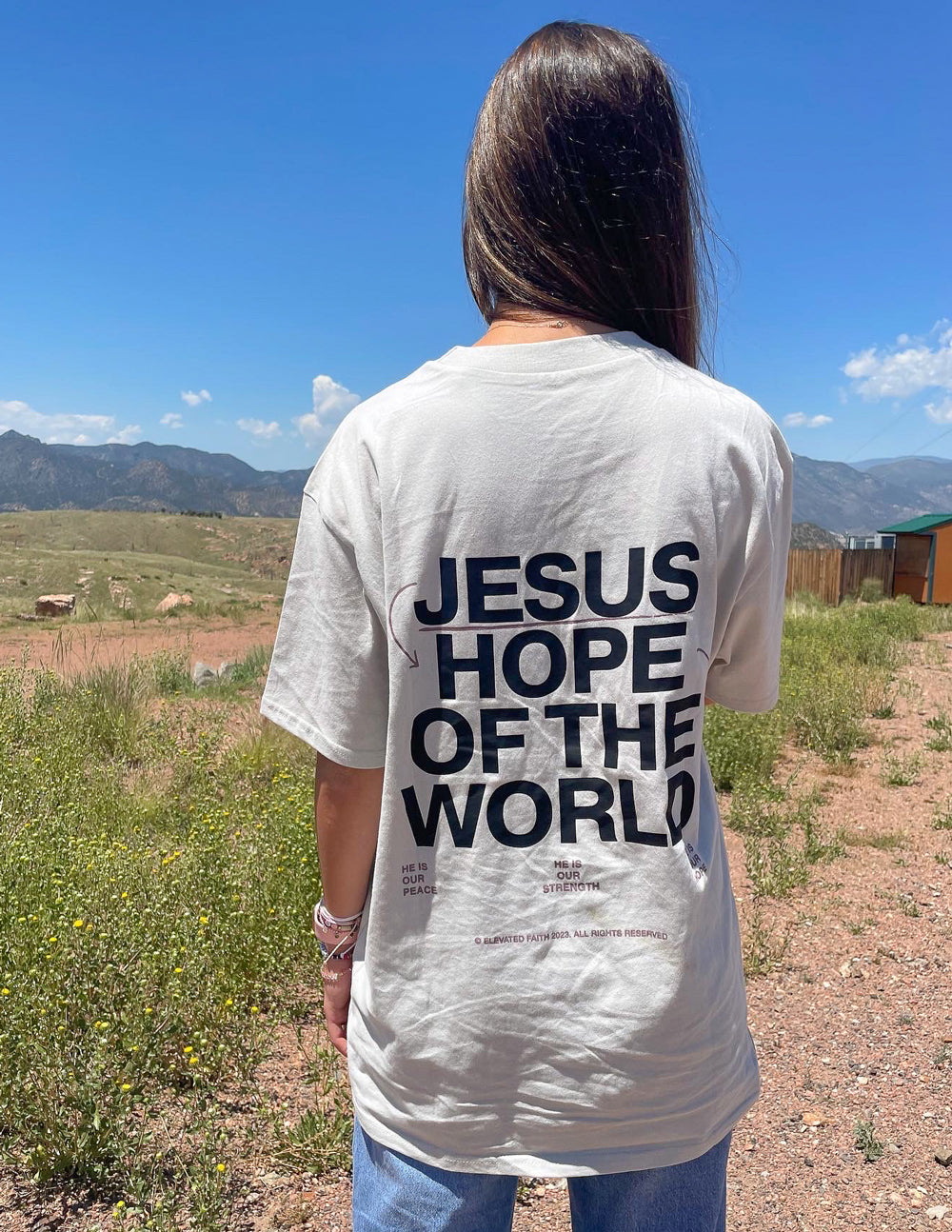 Unisex graphic tee, white, with back print text "JESUS HOPE OF THE WORLD"