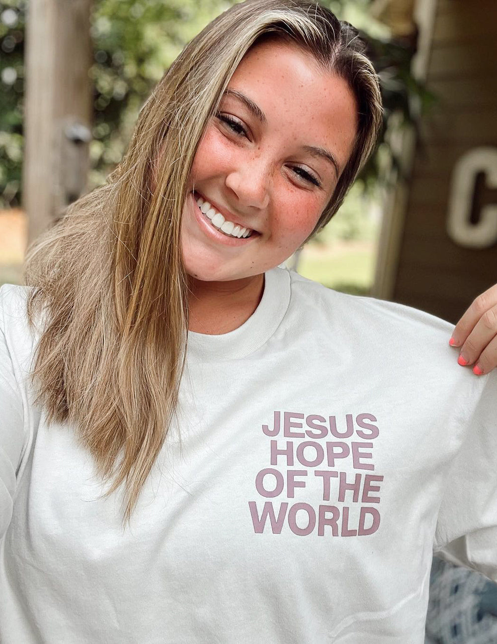 Unisex graphic tee, white, with front logo text "JESUS HOPE OF THE WORLD"