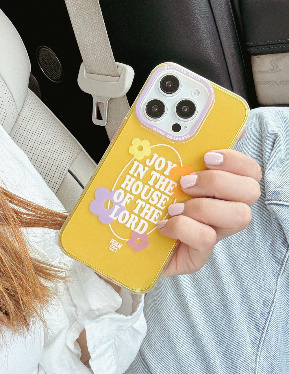 Yellow phone case with floral design and 'Joy in the House of the Lord' text, camera cutouts