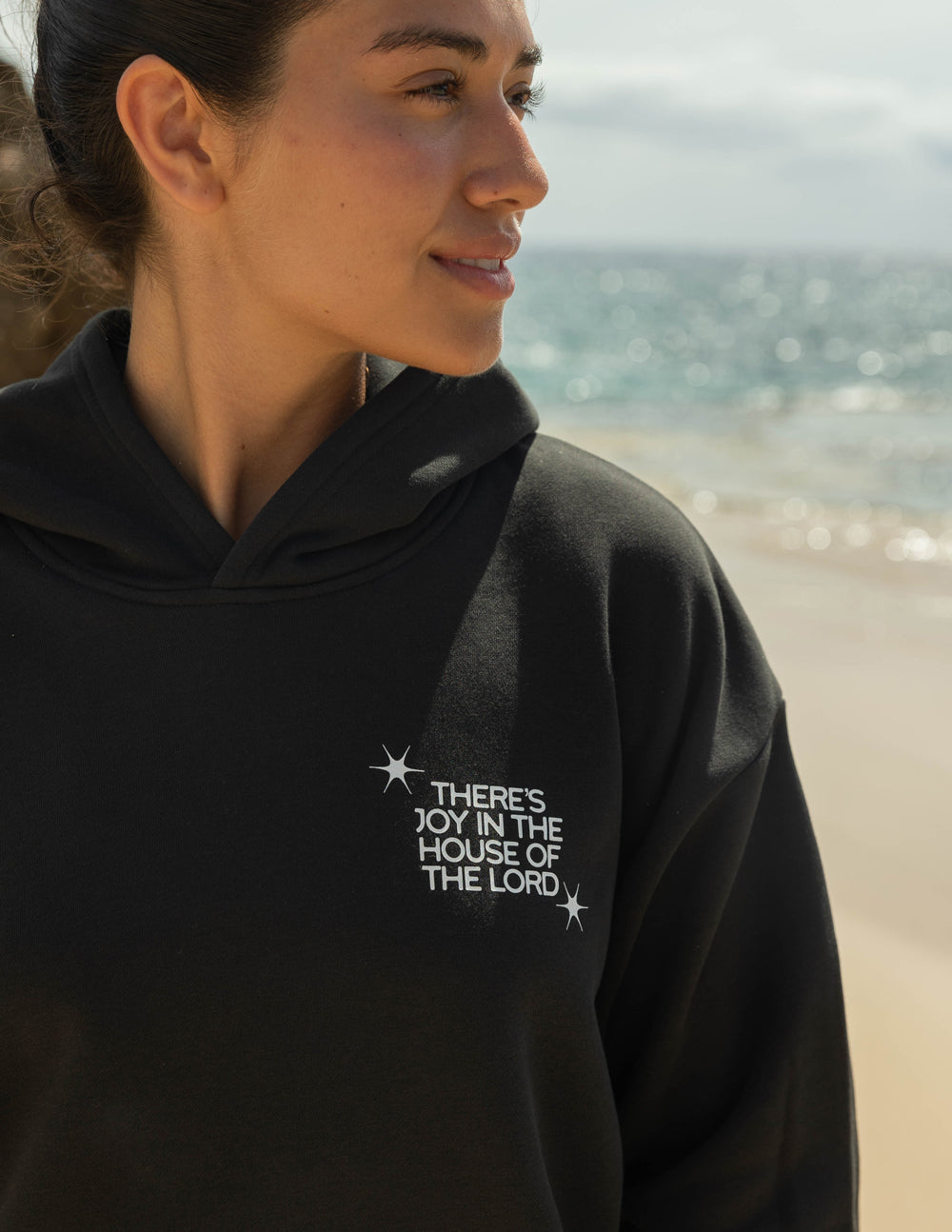 Black unisex hoodie with small front graphic logo and hood