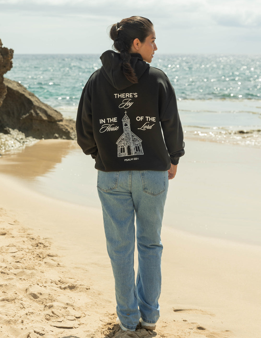 Black unisex hoodie with back house-and-cross graphic and hood