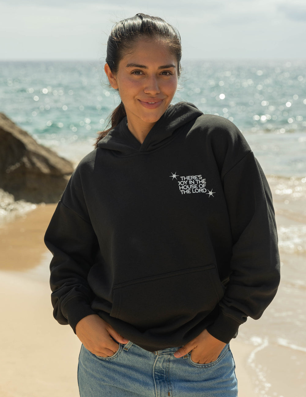 Black unisex hoodie with small chest graphic and kangaroo pocket