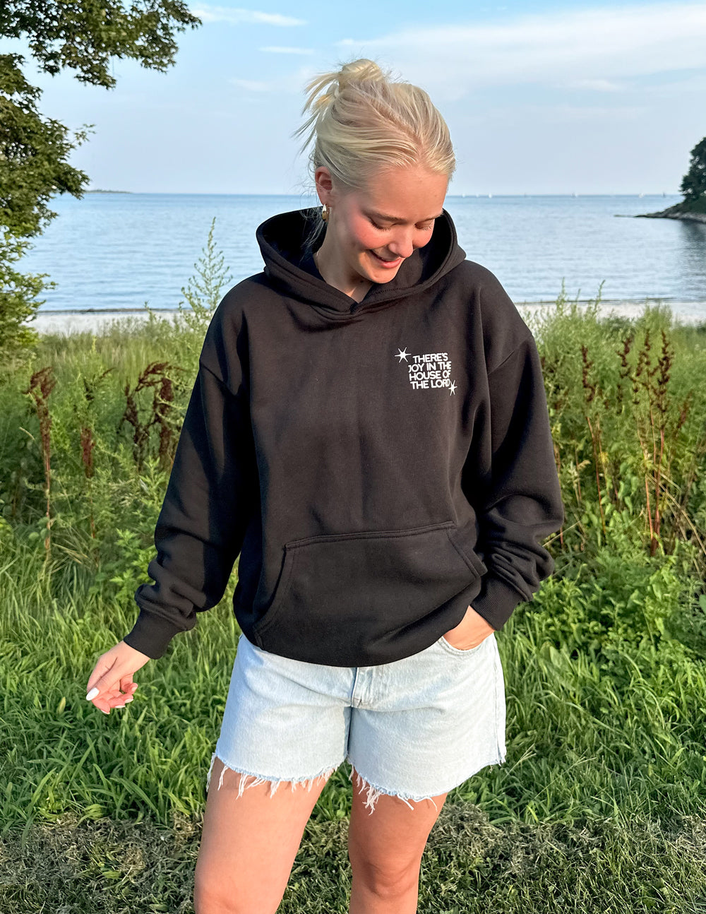 Black unisex hoodie with front chest logo and kangaroo pocket