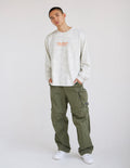 Long-sleeve heavyweight tee in white with orange front logo text