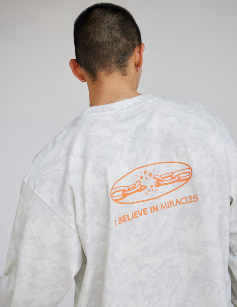 Long-sleeve heavyweight tee in white with large orange back graphic
