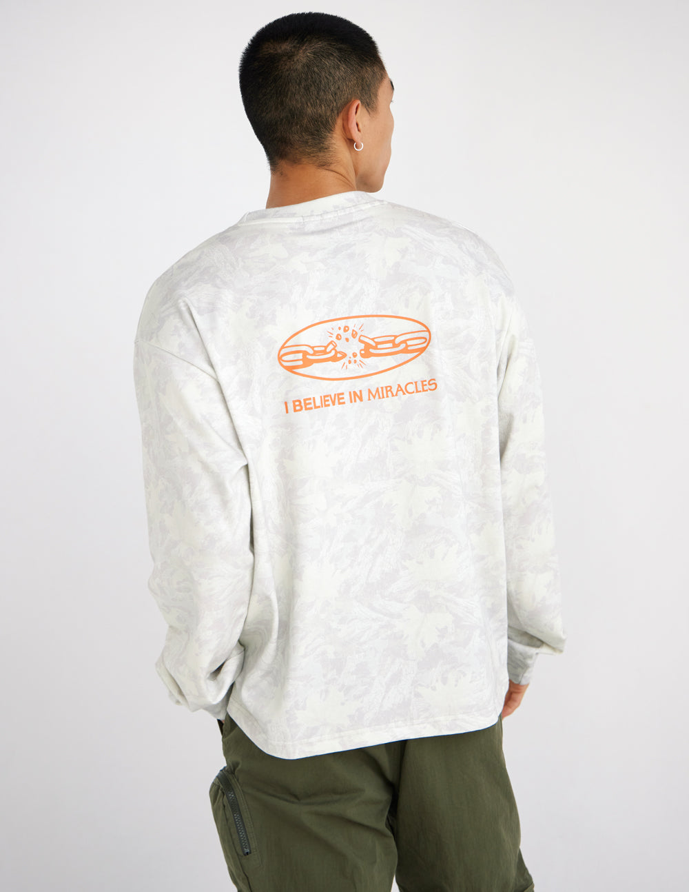 Long-sleeve heavyweight tee in white with orange back graphic and text