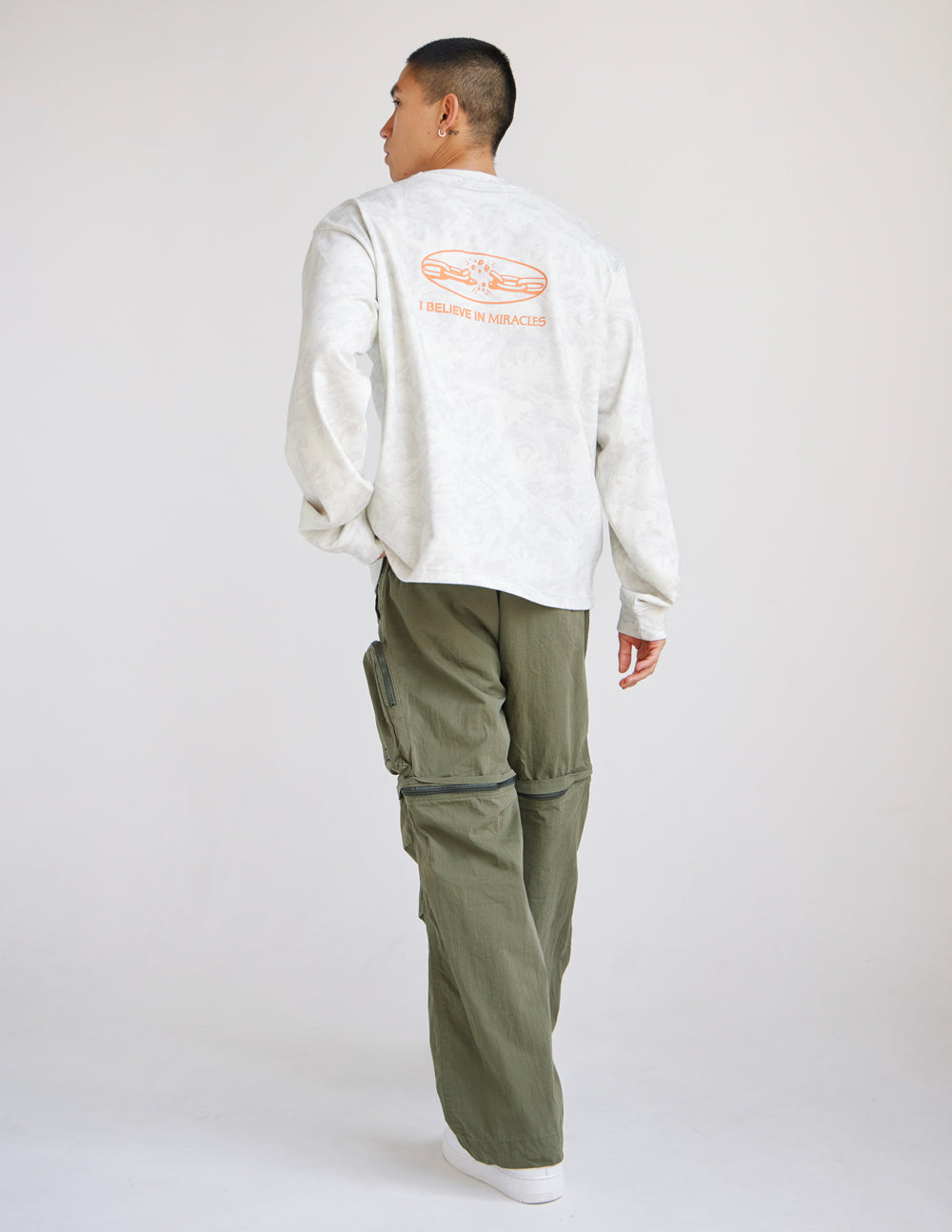 Long-sleeve heavyweight tee in white with orange back graphic and text