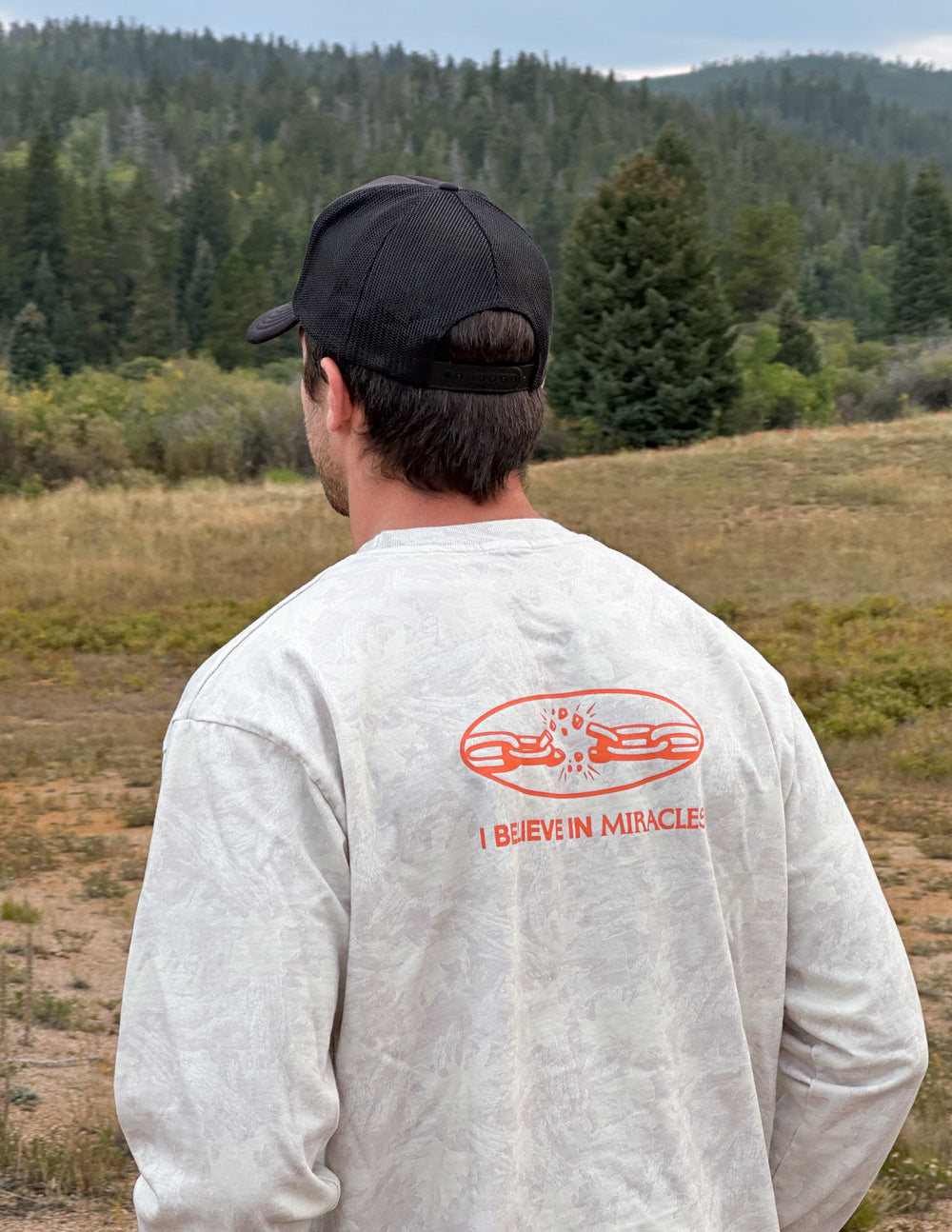 Long-sleeve heavyweight tee in white with orange back graphic and text