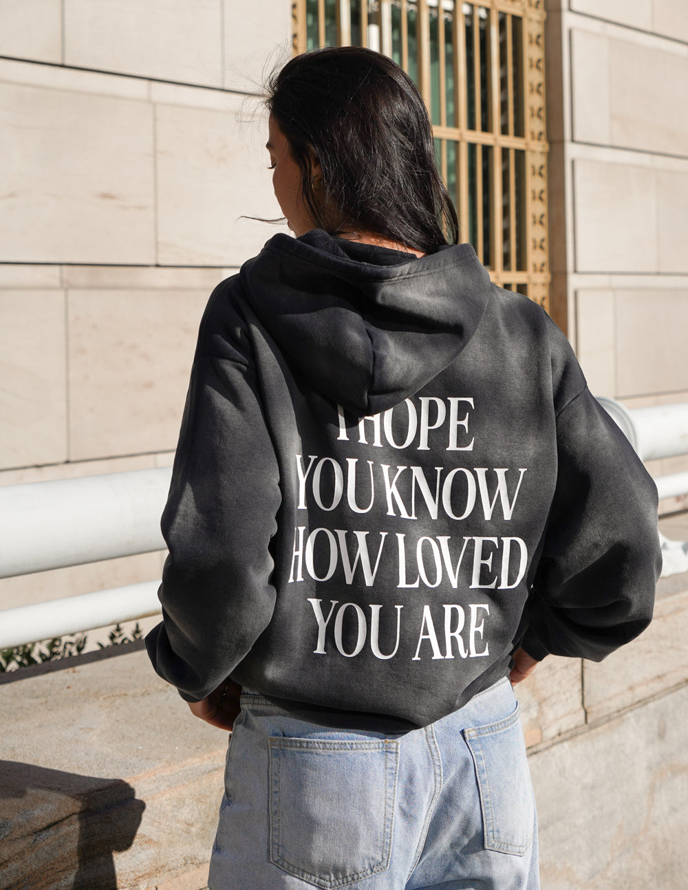 Dark unisex hoodie with bold back graphic print and hood