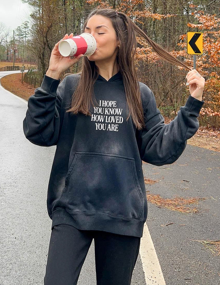 Dark unisex hoodie with front graphic print, hood, and kangaroo pocket