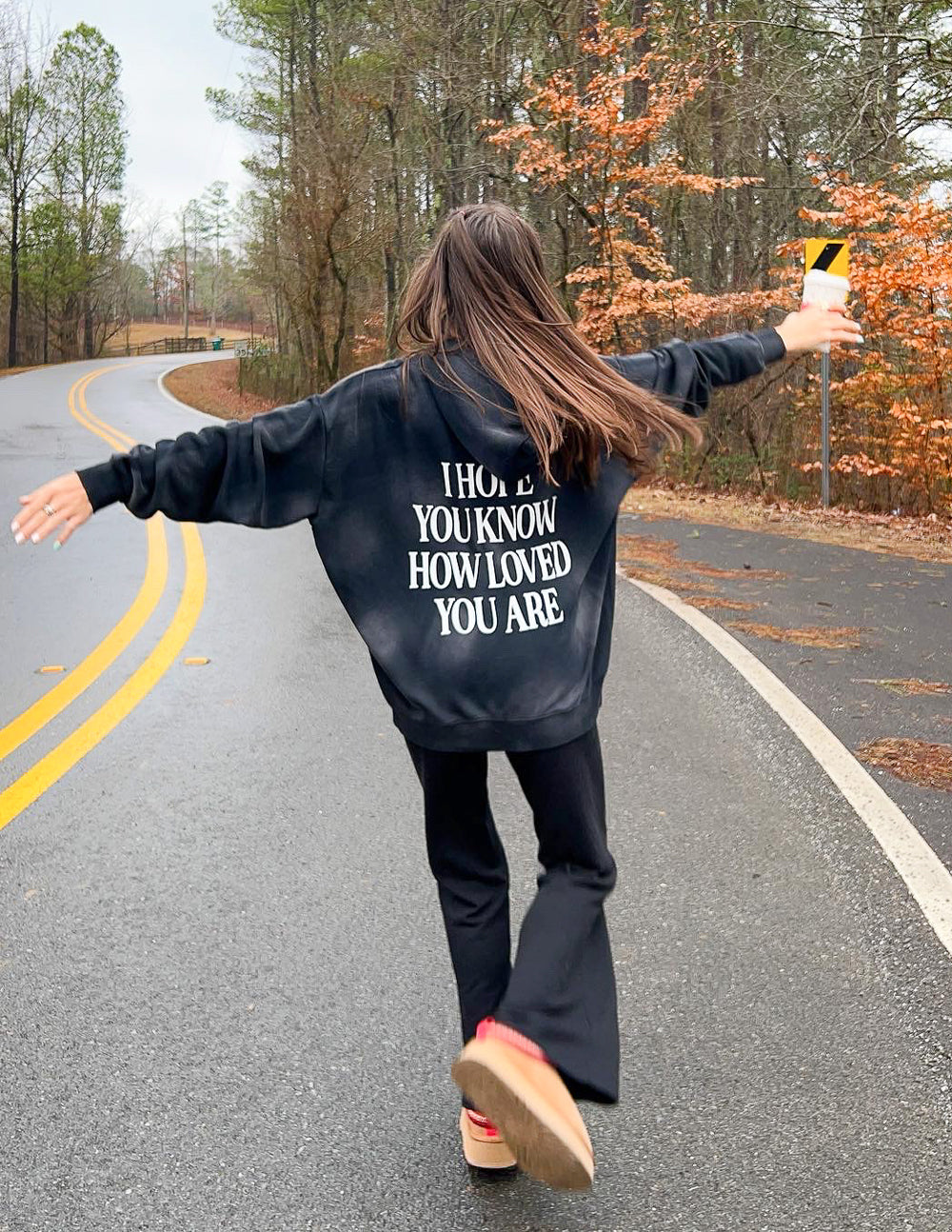 Unisex hoodie, dark charcoal, white text "I HOPE YOU KNOW HOW LOVED YOU ARE"