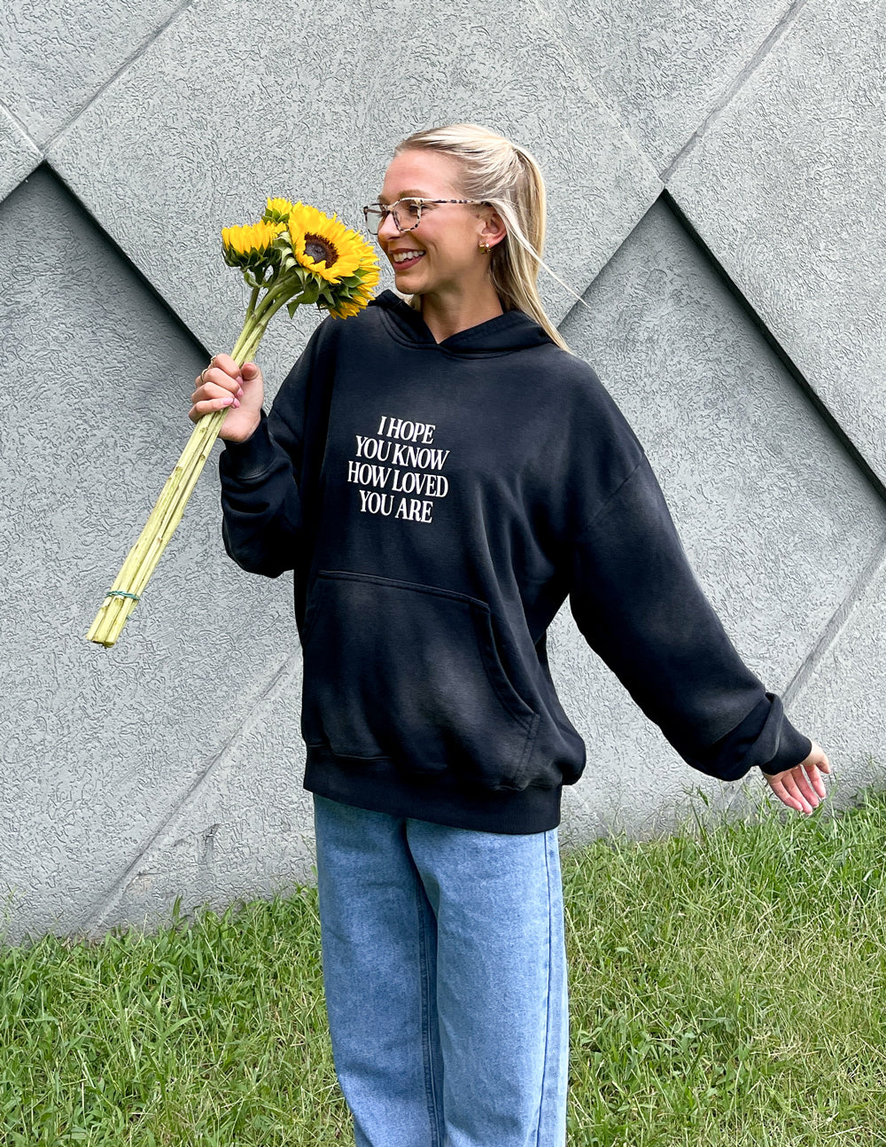 Dark unisex hoodie with front graphic print, hood, and kangaroo pocket