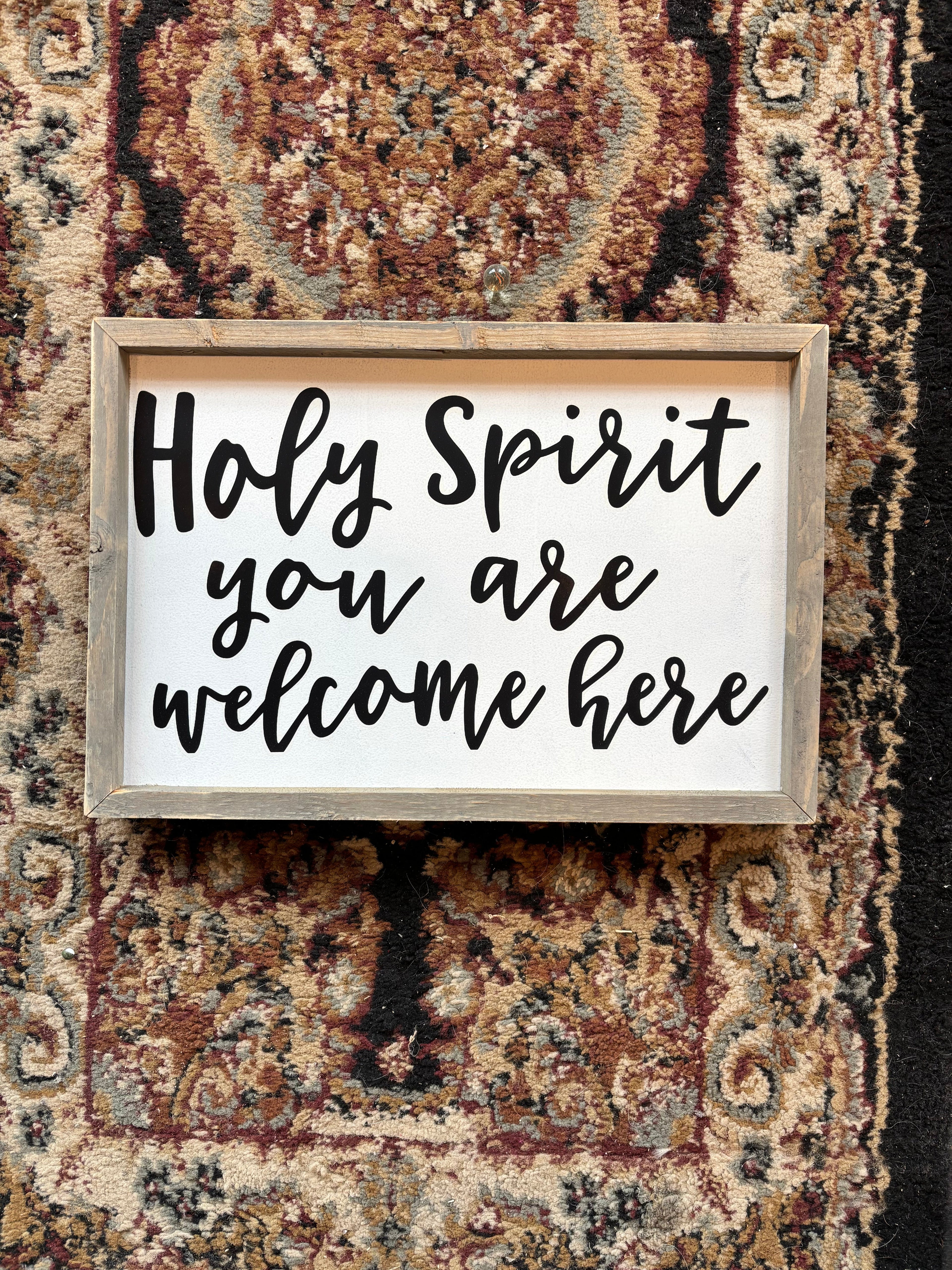 Wood-framed Christian welcome sign reading 'Holy Spirit you are welcome here'