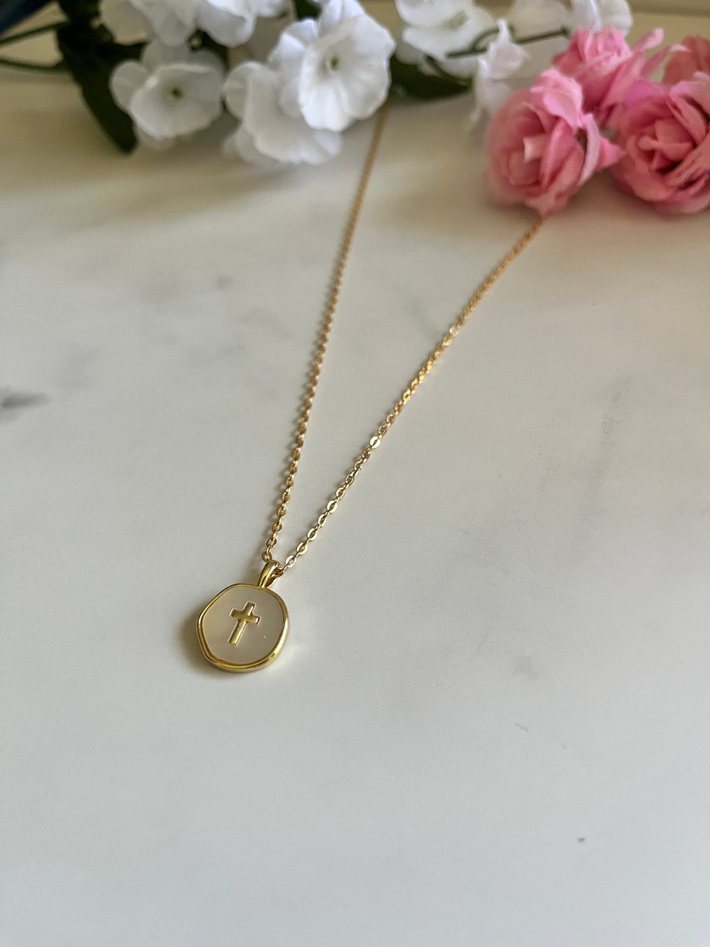Gold round cross pendant necklace with thin chain and circular charm