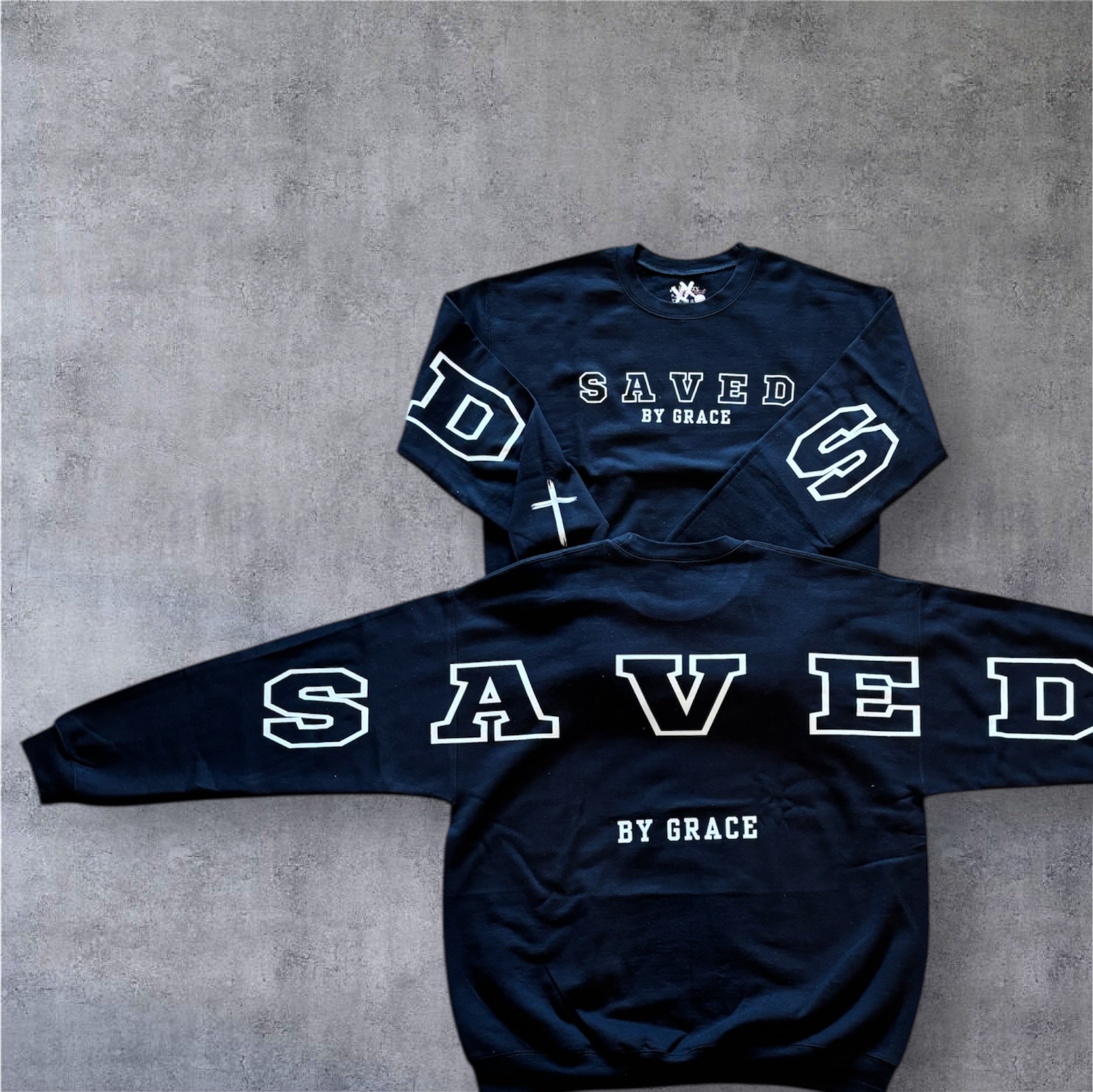 Navy crewneck sweatshirt with SAVED front graphic and crosses