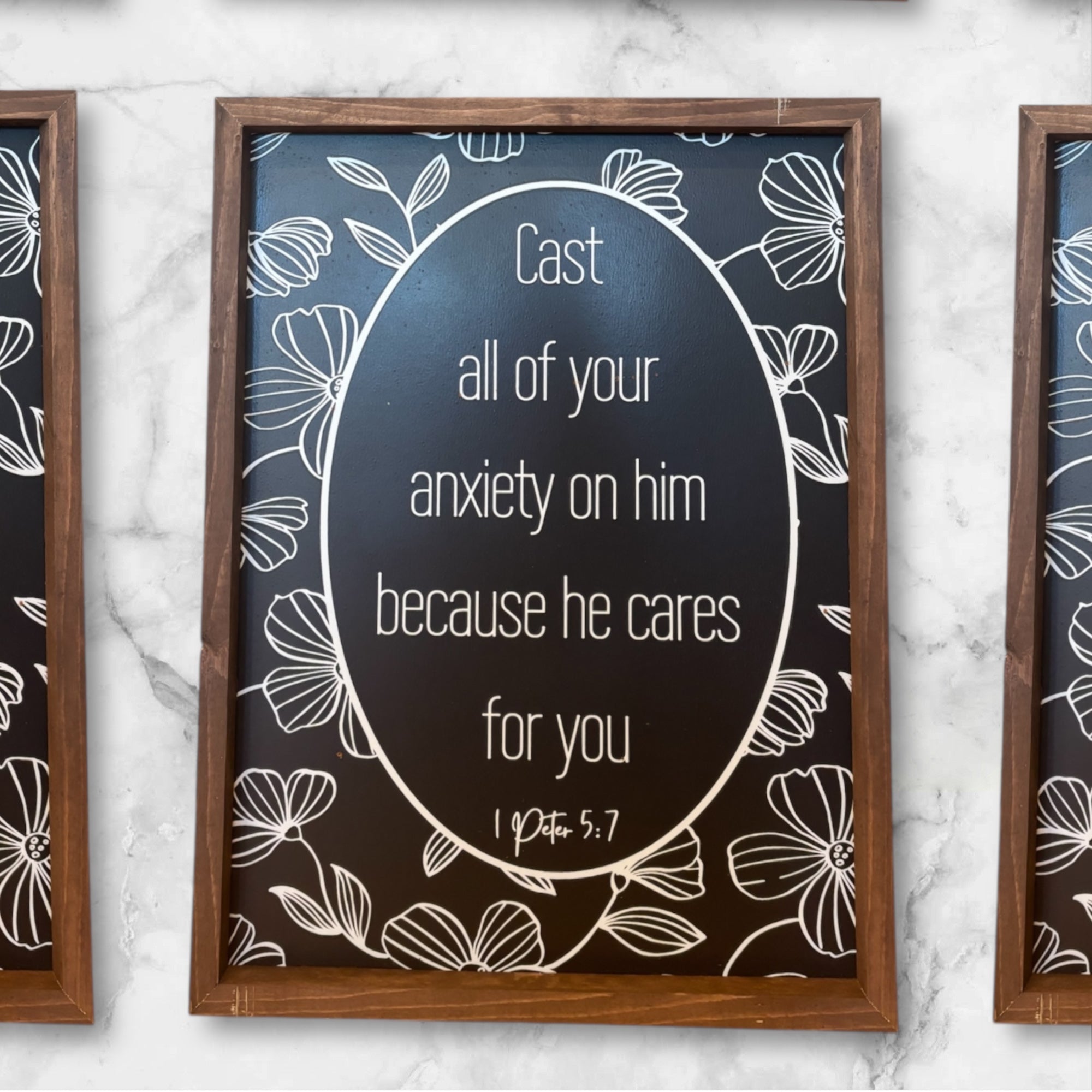 Framed inspirational wall art sign with white oval text on dark background