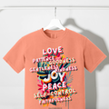 Coral T-shirt with colorful scripture-themed fruit and word graphic on front