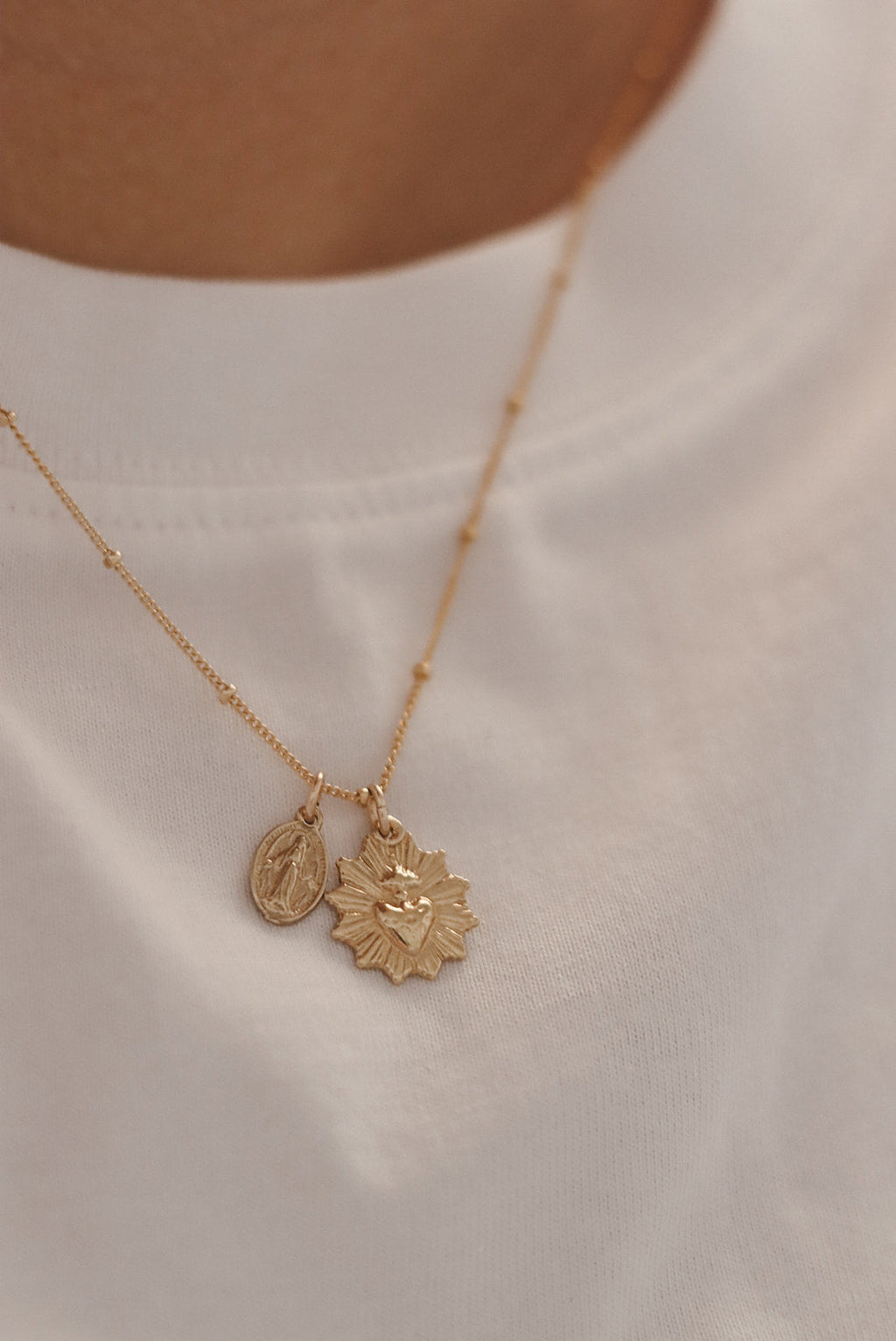 Gold heart and medal pendant necklace with two charms on delicate chain
