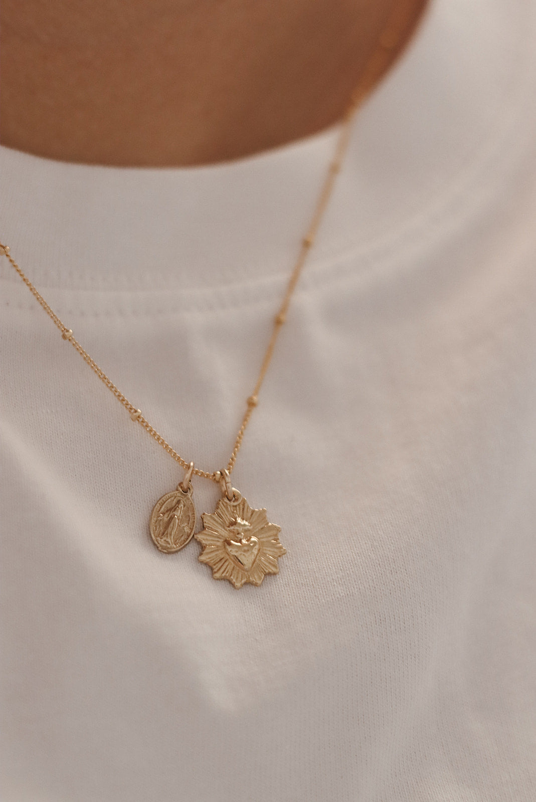 Gold heart and medal pendant necklace with two charms on delicate chain