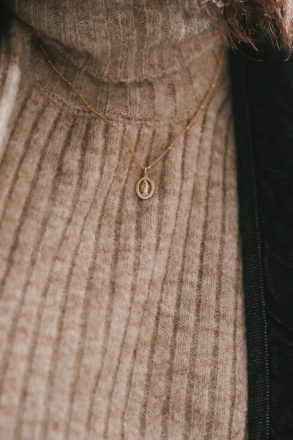 Gold-tone flat chain necklace with small round medal pendant