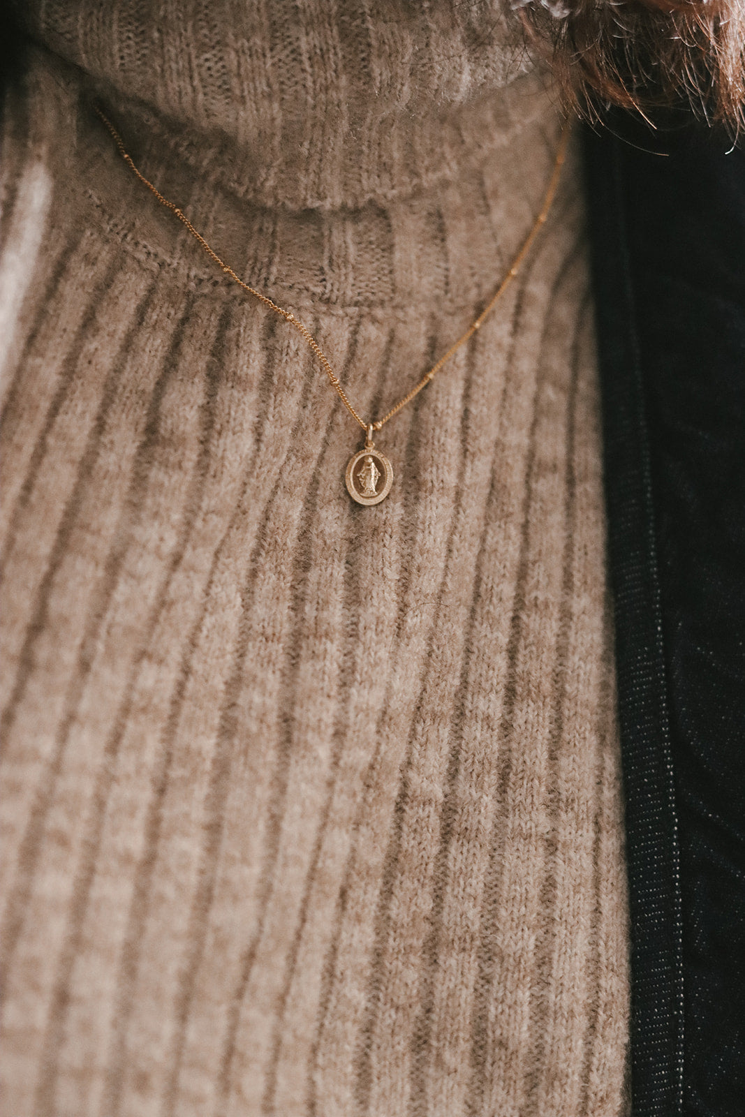 Gold-tone flat chain necklace with small round medal pendant